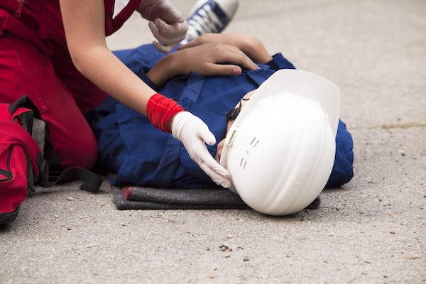 Medical care given to someone on the ground with a personal injury